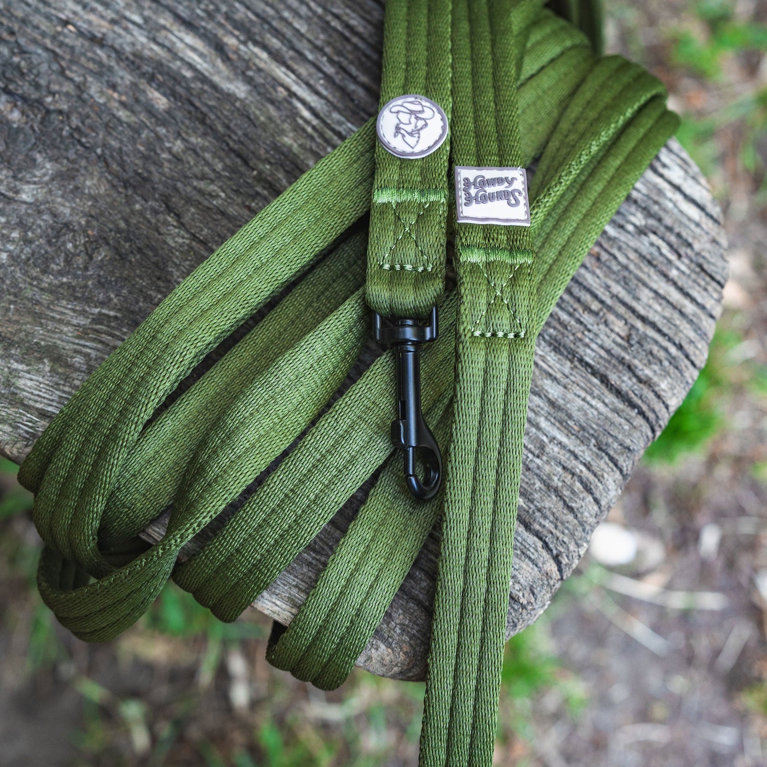 Green paracord on a wooden surface with a blurred natural background